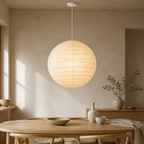 Akari D washi paper lantern pendant with white cord in a warm dining room