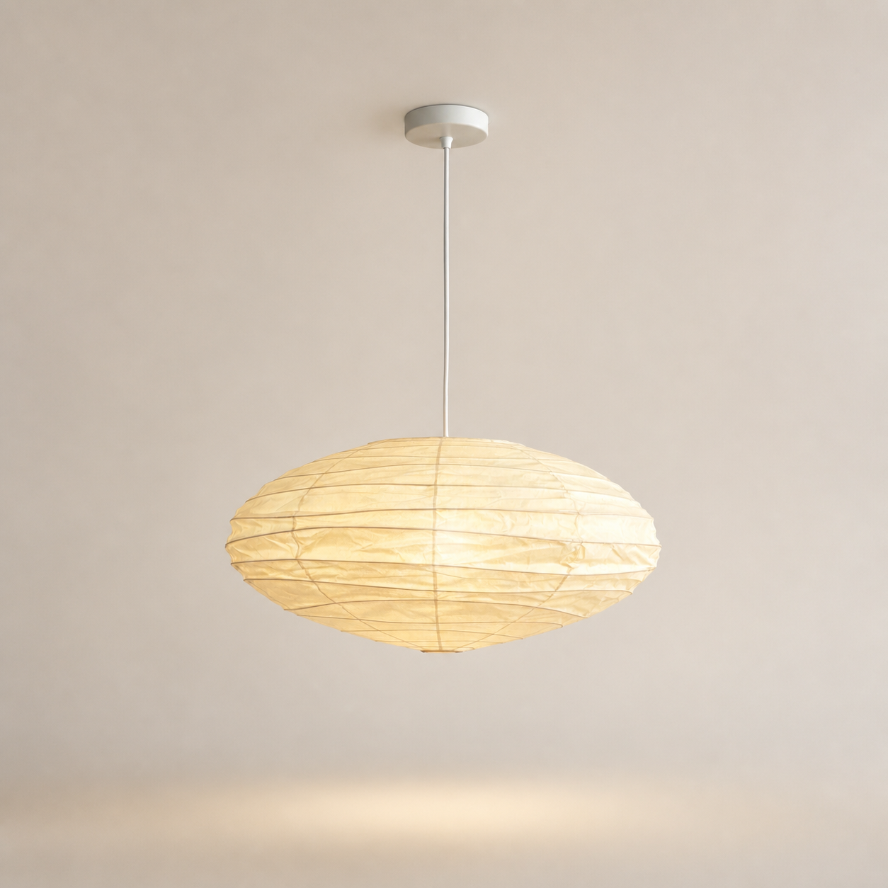 Akari EN oval washi paper pendant with white cord on a warm neutral background