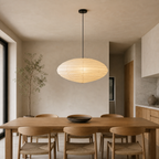 Akari EN 27.5 inch pendant with black cord above a dining table