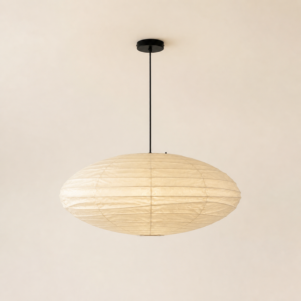 Akari EN oval washi paper pendant with black cord on a warm neutral background
