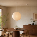 Akari round paper globe swag light, Dia 21.7 by H 20.5 inches, above a walnut dining table