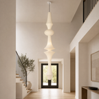 Akari tall rice paper E pendant light in a double-height foyer