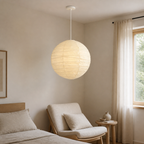 Akari D white cord paper lantern pendant in a calm bedroom reading corner