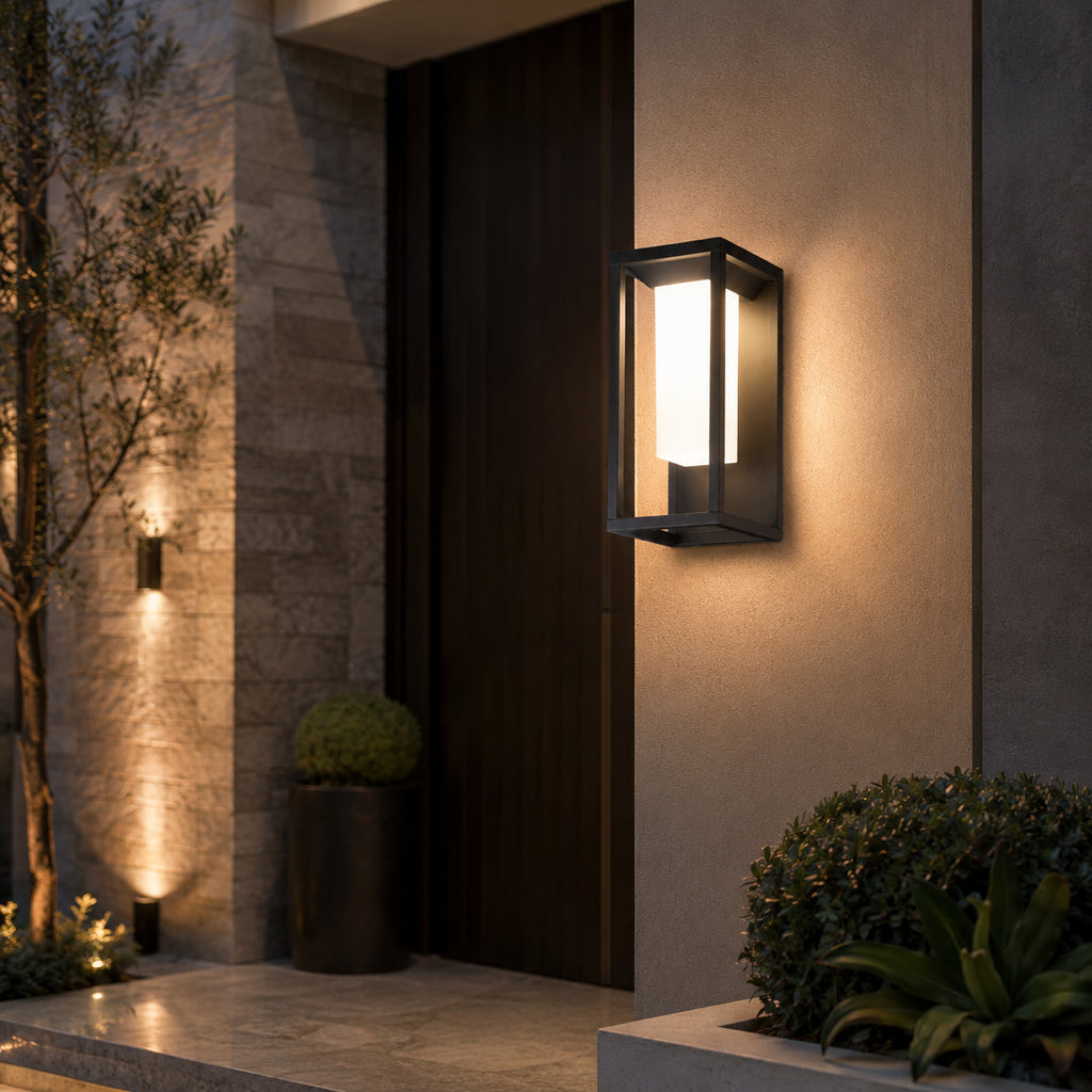 Avrn black outdoor wall light casting soft light on an exterior wall
