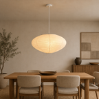 Akari A oval washi paper pendant light with white cord in a warm interior