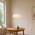 Small Akari 15A rice paper swag light with white cord in a ceiling-supported room scene