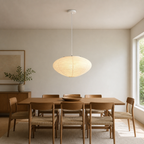 Akari A oval paper pendant light above a medium dining table