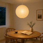 Akari washi paper globe pendant light in a calm nighttime reading space
