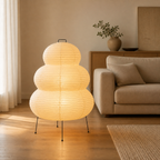 Akari Model B Large Japanese paper lantern floor lamp in a spacious living room